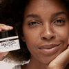 woman holding tub of skincare