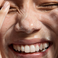 woman washing her face