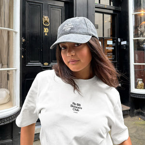 Model wearing no BS Skincare Club t shirt and cap