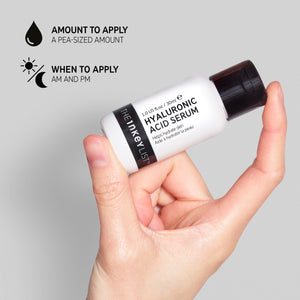 Hand holding Hyaluronic Acid Serum with black text explaining the amount to apply (pea-sized amount) and when to use it (AM and PM)
