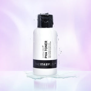 PHA Toner product against a purple background with some toner dripping down the bottle